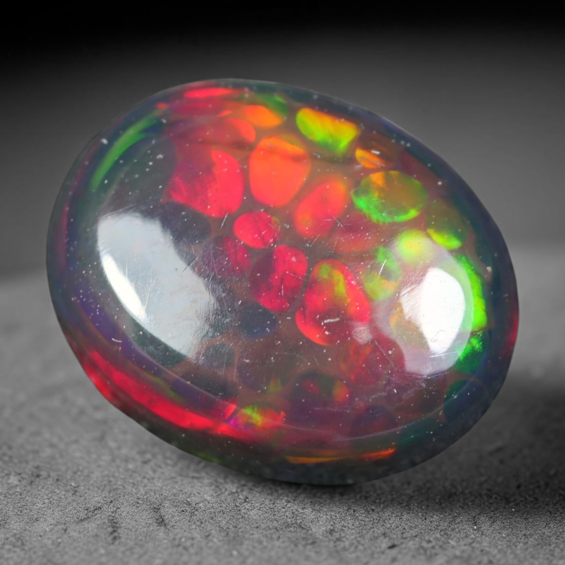 2.13ct Natural Ethiopian Welo Black Smoked Opal Cabochon Loose Gemstone, 57AK: This fully polished Ethiopian Welo opal features a dark smoked base with vivid, sweeping play-of-color shifting across its glossy dome surface, measured at 10.3x8.2x4.4mm. The black smoke treatment de