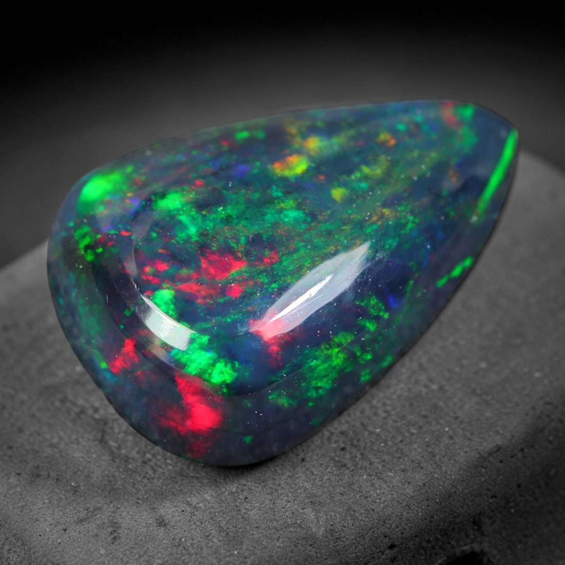 1.73ct Natural Ethiopian Welo Black Smoked Opal Cabochon Loose Gemstone, 75AK: This fully polished Ethiopian Welo opal features a dark smoked base with vivid, sweeping play-of-color shifting across its glossy dome surface, measured at 11.4x8.3x4.3mm. The black smoke treatment de