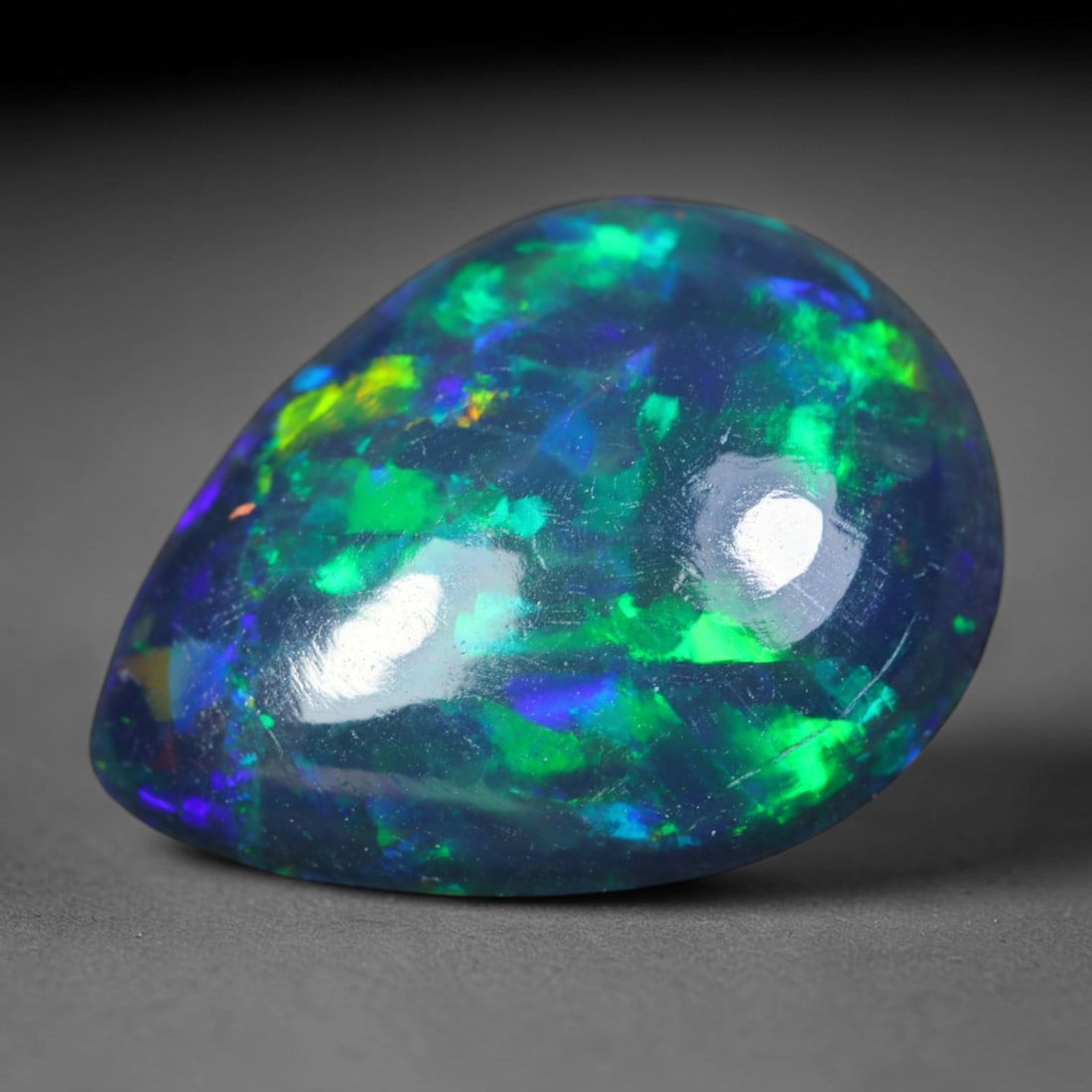 2.25ct Natural Ethiopian Welo Black Smoked Opal Cabochon Loose Gemstone, 78AK: This fully polished Ethiopian Welo opal features a dark smoked base with vivid, sweeping play-of-color shifting across its glossy dome surface, measured at 12.3x9.5x4.2mm. The black smoke treatment de