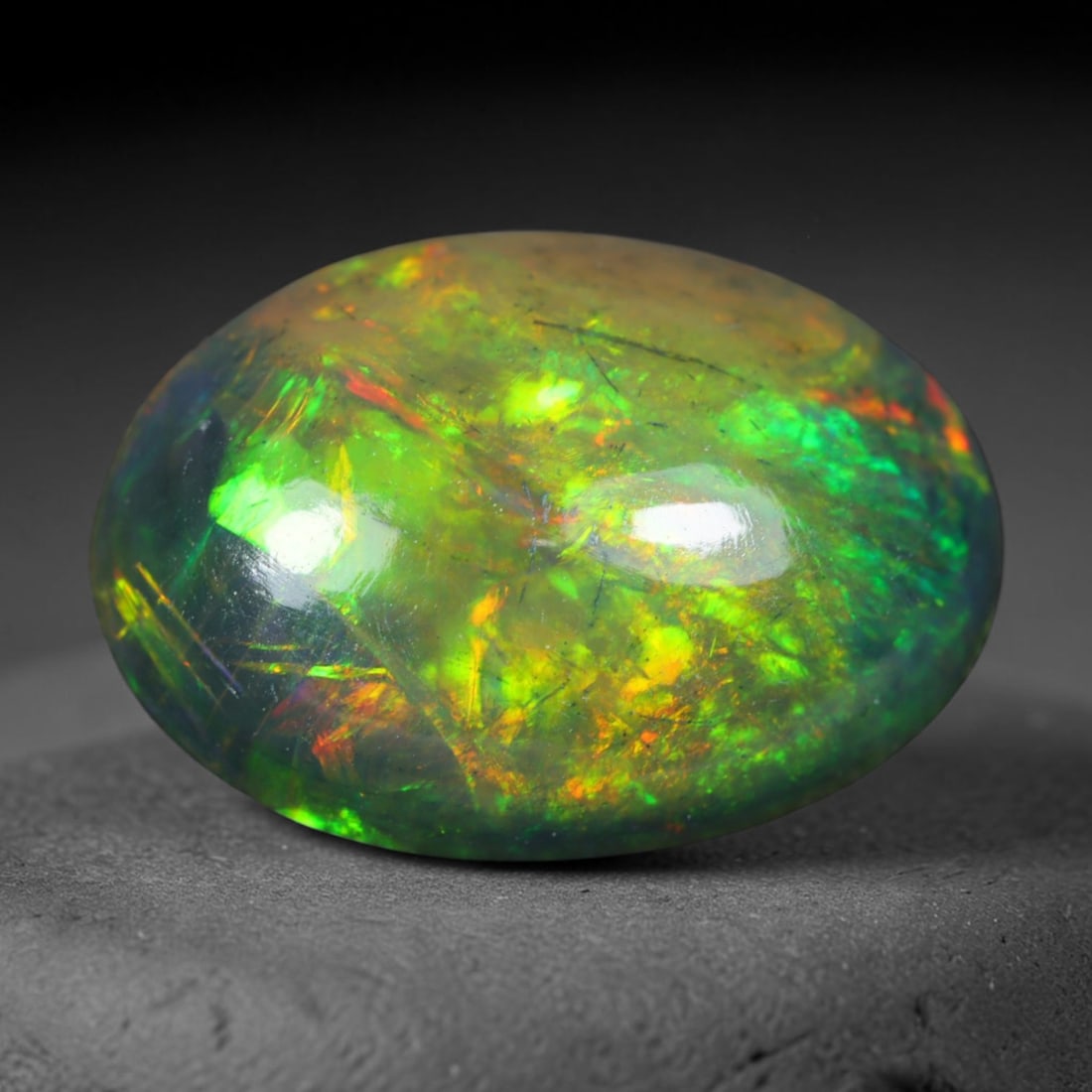 2.50ct Natural Ethiopian Welo Black Smoked Opal Cabochon Loose Gemstone, 80AK: This fully polished Ethiopian Welo opal features a dark smoked base with vivid, sweeping play-of-color shifting across its glossy dome surface, measured at 11.8x8.6x5mm. The black smoke treatment deep