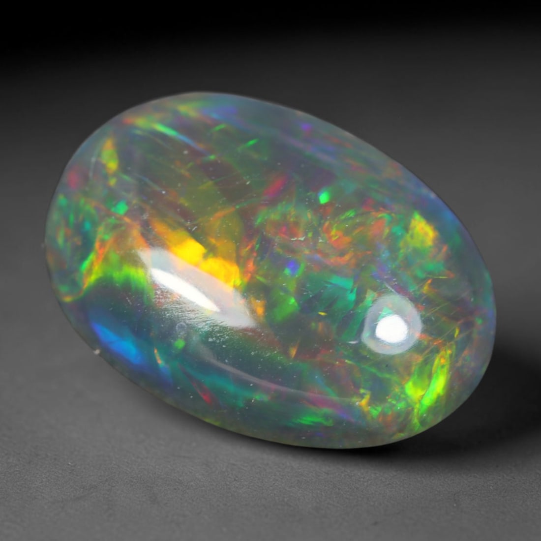 2.52ct Natural Ethiopian Welo Black Smoked Opal Cabochon Loose Gemstone, 56AK: This fully polished Ethiopian Welo opal features a dark smoked base with vivid, sweeping play-of-color shifting across its glossy dome surface, measured at 12.7x9.2x4.3mm. The black smoke treatment de