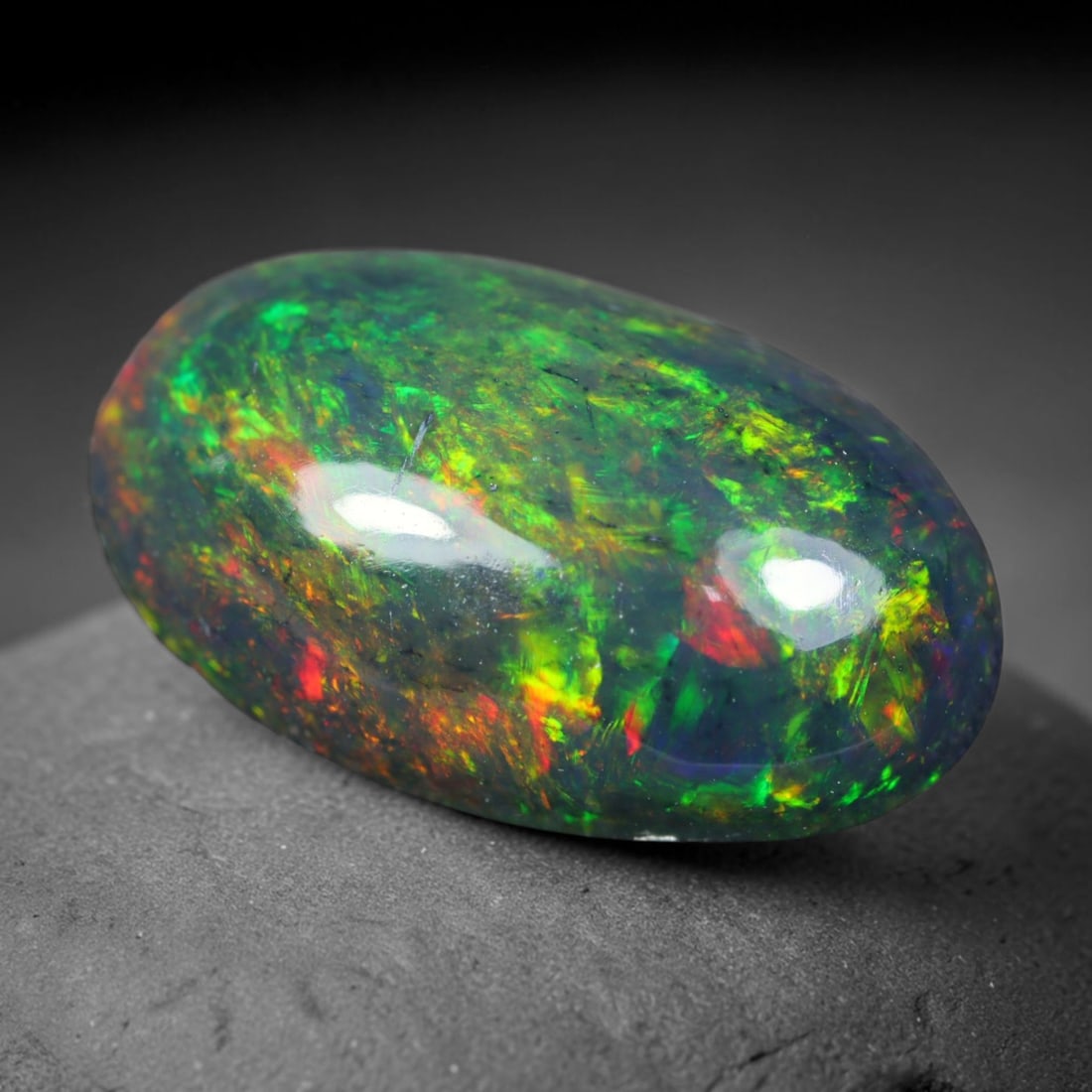 2.60ct Natural Ethiopian Welo Black Smoked Opal Cabochon Loose Gemstone, 66AK: This fully polished Ethiopian Welo opal features a dark smoked base with vivid, sweeping play-of-color shifting across its glossy dome surface, measured at 13.3x8x4.8mm. The black smoke treatment deep