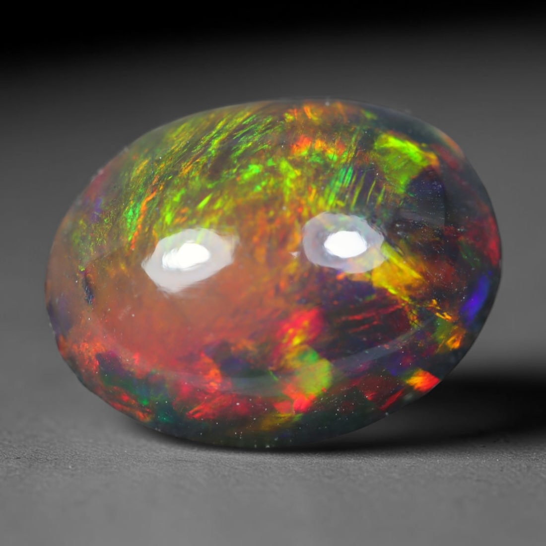 2.70ct Natural Ethiopian Welo Black Smoked Opal Cabochon Loose Gemstone, 79AK: This fully polished Ethiopian Welo opal features a dark smoked base with vivid, sweeping play-of-color shifting across its glossy dome surface, measured at 11.3x8.8x5.5mm. The black smoke treatment de