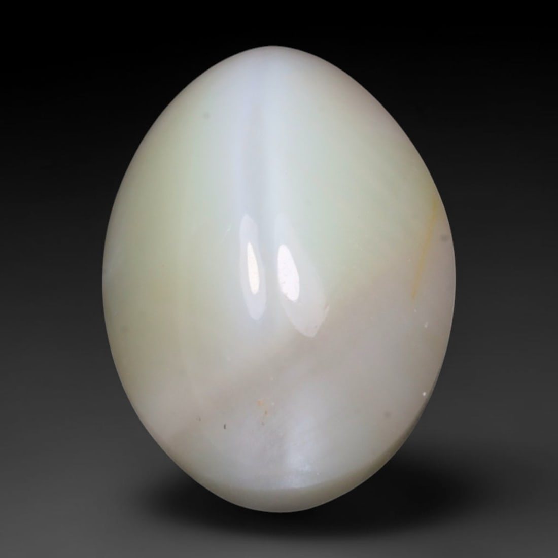 2.10 Carats Natural Ceylon Chrysoberyl Cat's Eye Loose Gemstone, 98AK: This polished Ceylon chrysoberyl cabochon displays a sharp, distinct silvery chatoyant band running across its smooth surface, formed by dense aligned microscopic rutile inclusions inherent to genuine