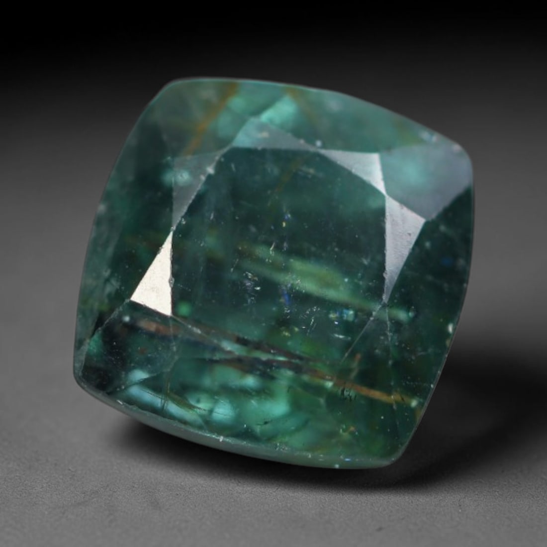 1.26 Carats Natural Mozambique Teal Green Tourmaline Loose Gemstone, 43AK: This transparent Mozambique tourmaline features rich deep teal green saturation, threaded with distinct natural metallic needle mineral inclusions and subtle internal fissures across the crystal body,