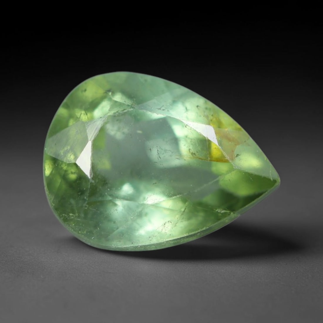 1.51 Carats Natural Mozambique Sage Green Tourmaline Loose Gemstone, 25AK: This transparent Mozambique tourmaline displays a delicate light sage green shade, featuring subtle natural fine fissures and scattered tiny mineral micro-inclusions within its crystal matrix, measure