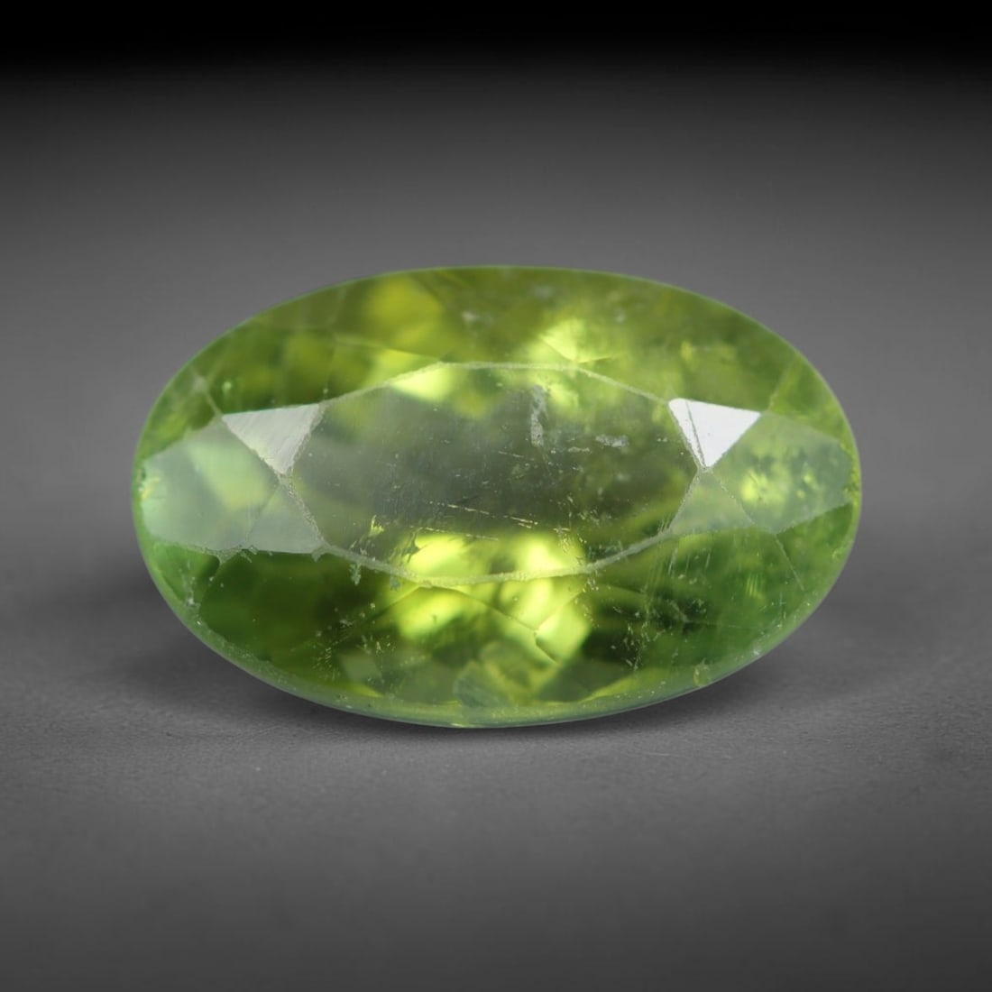 2.55 Carats Natural Mozambique Olive Green Tourmaline Loose Gemstone, 17AK: This transparent Mozambique tourmaline exhibits a soft olive green body tone, interspersed with subtle natural fine fissures and faint mineral trace inclusions within its crystal matrix, measured at 1
