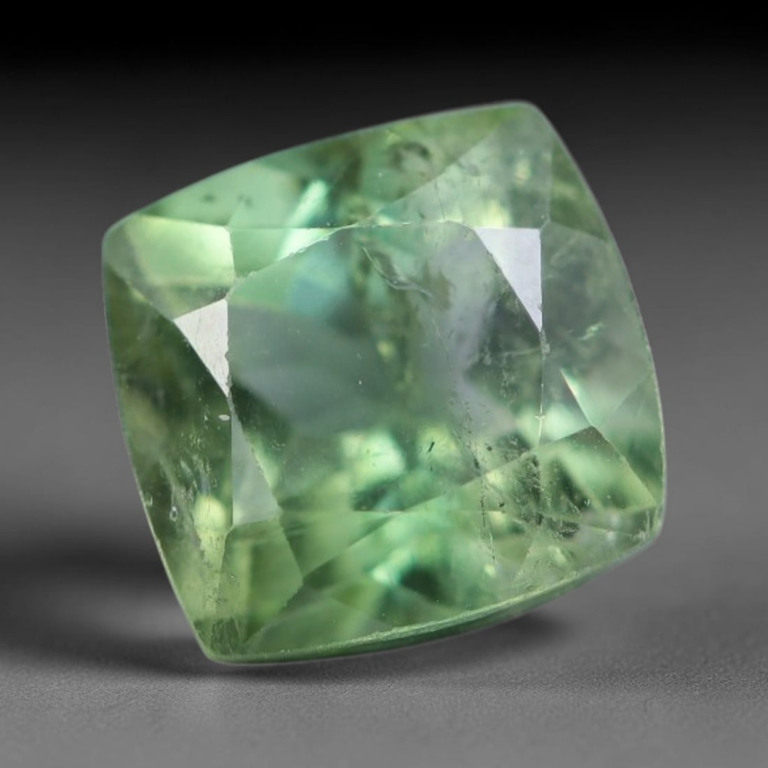 1.27 Carats Natural Mozambique Sage Green Tourmaline Loose Gemstone, 45AK: This transparent Mozambique tourmaline displays a delicate light sage green shade, featuring subtle natural fine fissures and scattered tiny mineral micro-inclusions within its crystal matrix, measure