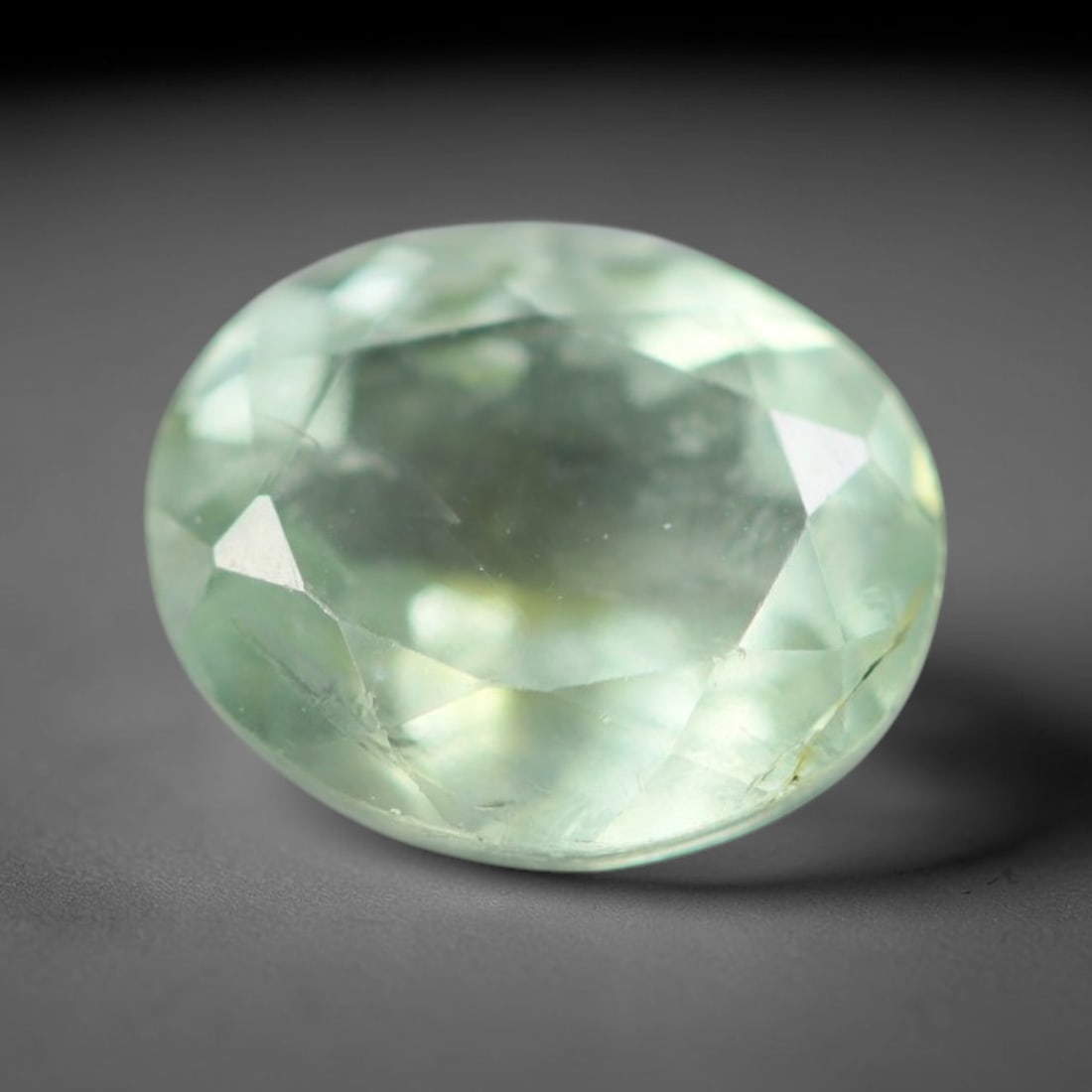 1.37 Carats Natural Mozambique Pale Mint Green Tourmaline Loose Gemstone, 40AK: This transparent Mozambique tourmaline displays a soft pale mint green hue, with delicate native fine fissures and tiny mineral specks distributed across its crystal interior, measured at 7.7x6.3x4mm.