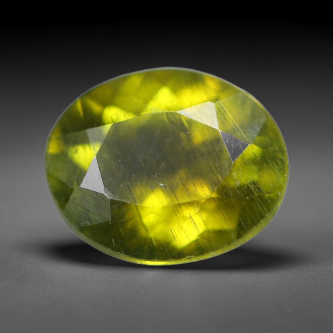 1.27 Carats Natural Mozambique Olive Yellow Tourmaline Loose Gemstone, 47AK: This transparent Mozambique tourmaline features a rich olive-yellow tone, marked by dense fine native linear internal striations and tiny mineral flecks running throughout its crystal structure, measu