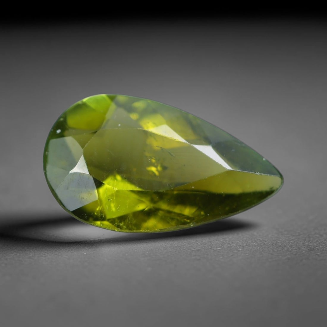 1.51 Carats Natural Mozambique Olive Yellow Tourmaline Loose Gemstone, 37AK: This transparent Mozambique tourmaline boasts a rich olive yellow hue, with faint native mineral specks and subtle internal fine fissures spread throughout its crystal interior, measured at 11x6.4x3.6
