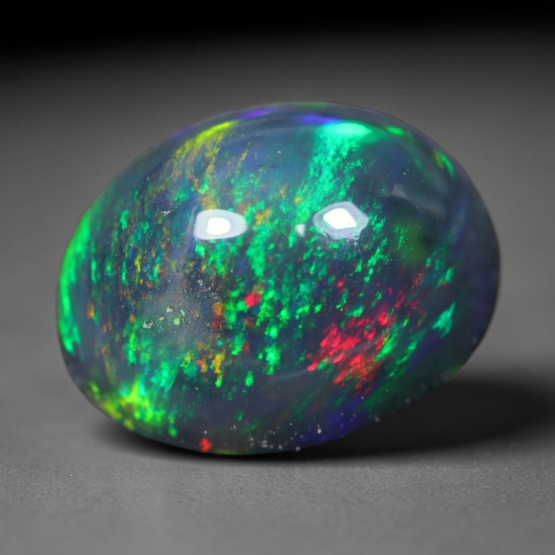 2.29ct Natural Ethiopian Welo Black Smoked Opal Cabochon Loose Gemstone, 40FL: This fully polished Ethiopian Welo opal features a dark smoked base with vivid, sweeping play-of-color shifting across its glossy dome surface, measured at 10.3x8.1x5.5mm. The black smoke treatment de