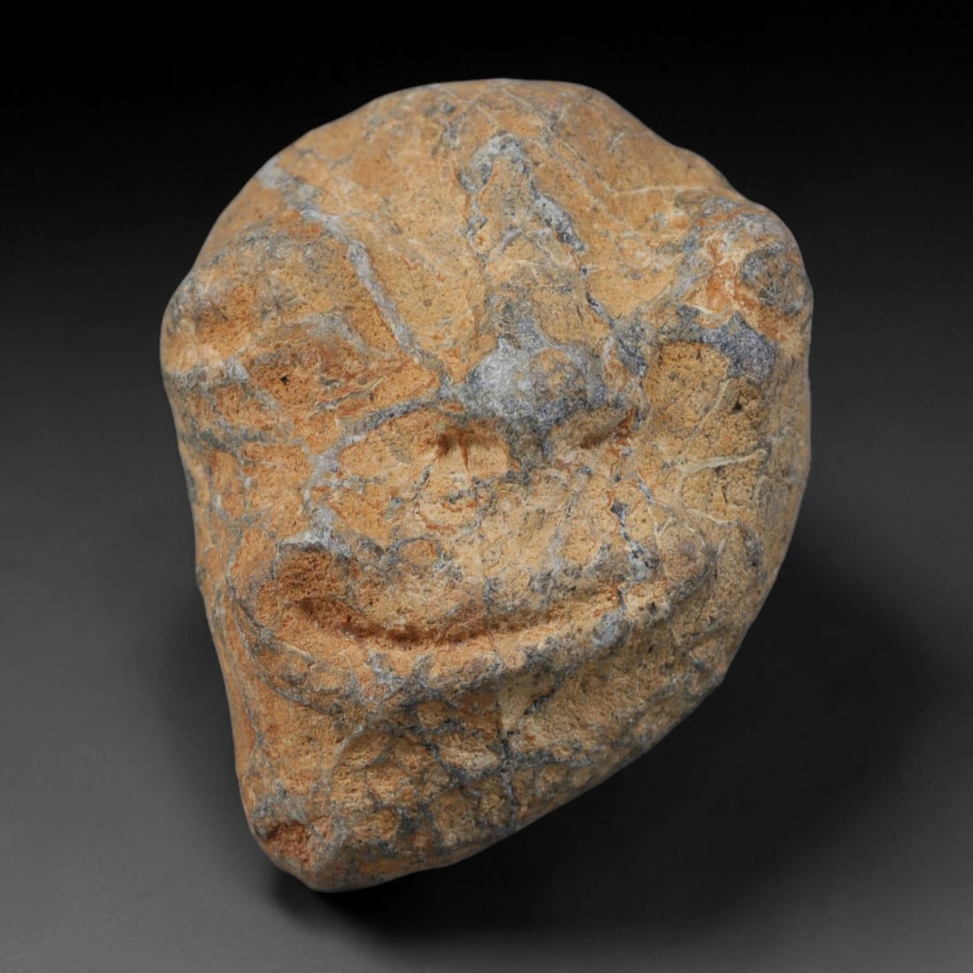 Ancient Medieval Mediterranean Hand Carved Stone Maskette Amulet, 62AP: Miniature wearable sacred talisman hand hewn from natural soft stone, originating from Medieval Mediterranean cultural craft traditions. Small carved stone amulets were widespread personal artifacts a