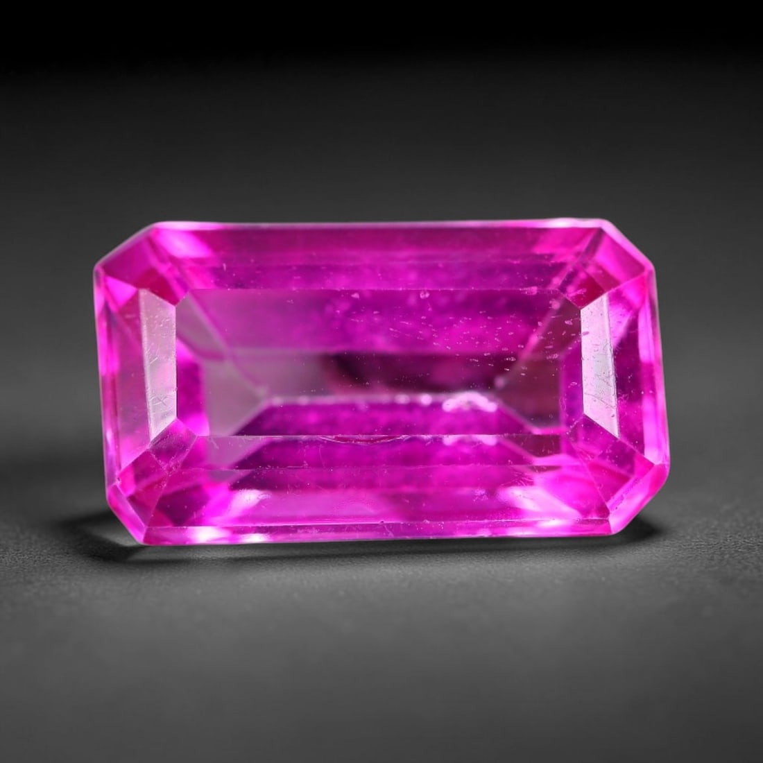 8.96 Carats Natural Brazil Hot Pink Topaz Loose Gemstone, 14FE: This natural Brazil topaz holds dimension measurements of 15.5x9x6.5mm, displaying an intense vibrant hot pink shade created through surface color coating treatment, its transparent crystal body carri