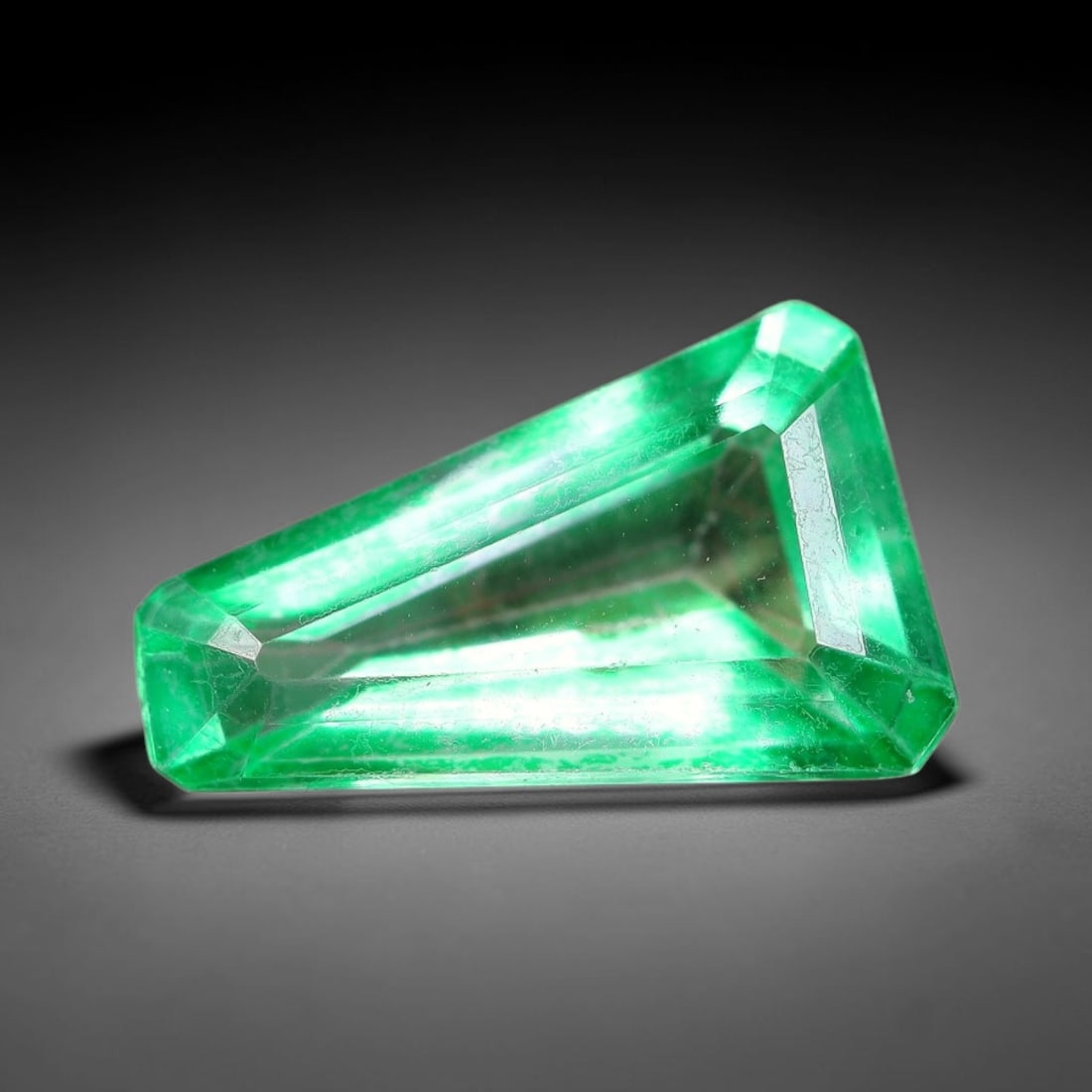 5.76 Carats Natural Brazil Vivid Green Topaz Loose Gemstone, 10FE: This natural Brazil topaz with recorded dimensions of 15.8x9.7x5.5mm, featuring a bright saturated green tone achieved via color coating treatment across the gem surface, with faint subtle natural int