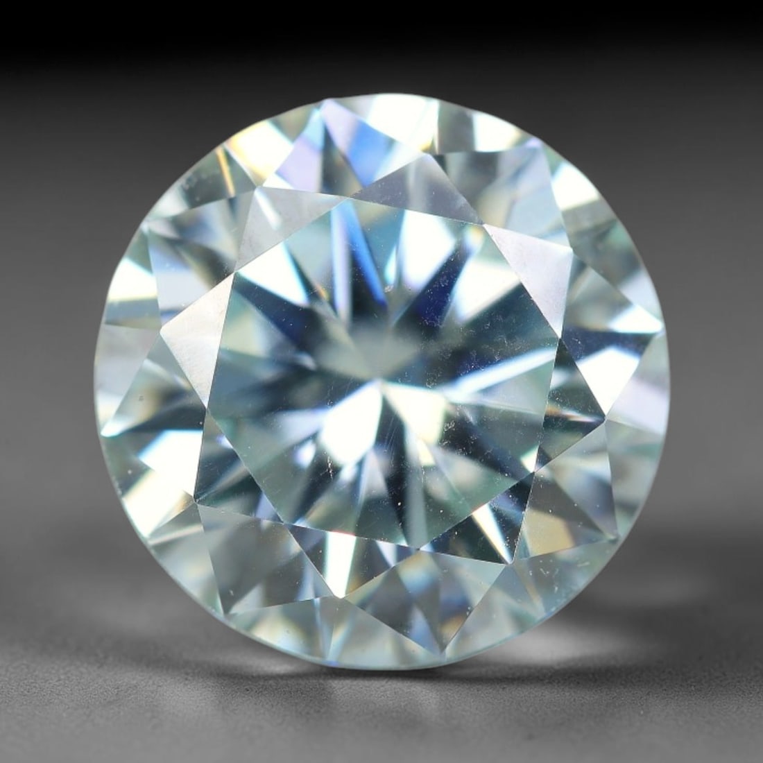 2.52 Carats Natural Cool White Moissanite Loose Gemstone, 26FL: This cool white moissanite holds dimension measurements of 9x5.4mm, delivering exceptional light dispersion that generates vivid rainbow sparkle across its fully transparent body, with faint microscop