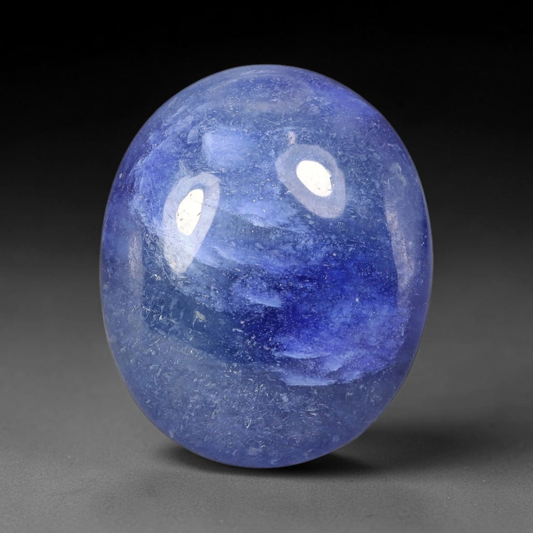 17.46 Carats Natural Madagascar Deep Cobalt Blue Sapphire Loose Gemstone, 22FE: This Madagascar sapphire cabochon has dimensions measuring 18.8x15.6x5.7mm, featuring rich cobalt blue color blended with soft natural pale veining that creates unique layered visual texture across th