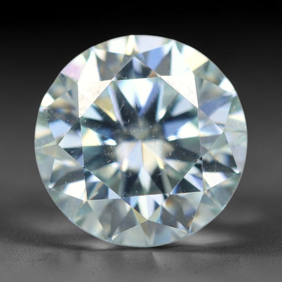 2.56 Carats Natural Cool White Moissanite Loose Gemstone, 44FE: This cool white moissanite holds dimension measurements of 9x5.4mm, delivering exceptional light dispersion that generates vivid rainbow sparkle across its fully transparent body, with faint microscop