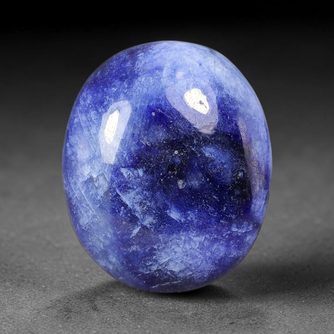 12.41 Carats Natural Madagascar Deep Cobalt Blue Sapphire Loose Gemstone, 16FE: This Madagascar sapphire cabochon has dimensions measuring 17.1x14.3x4.5mm, featuring rich cobalt blue color blended with soft natural pale veining that creates unique layered visual texture across th