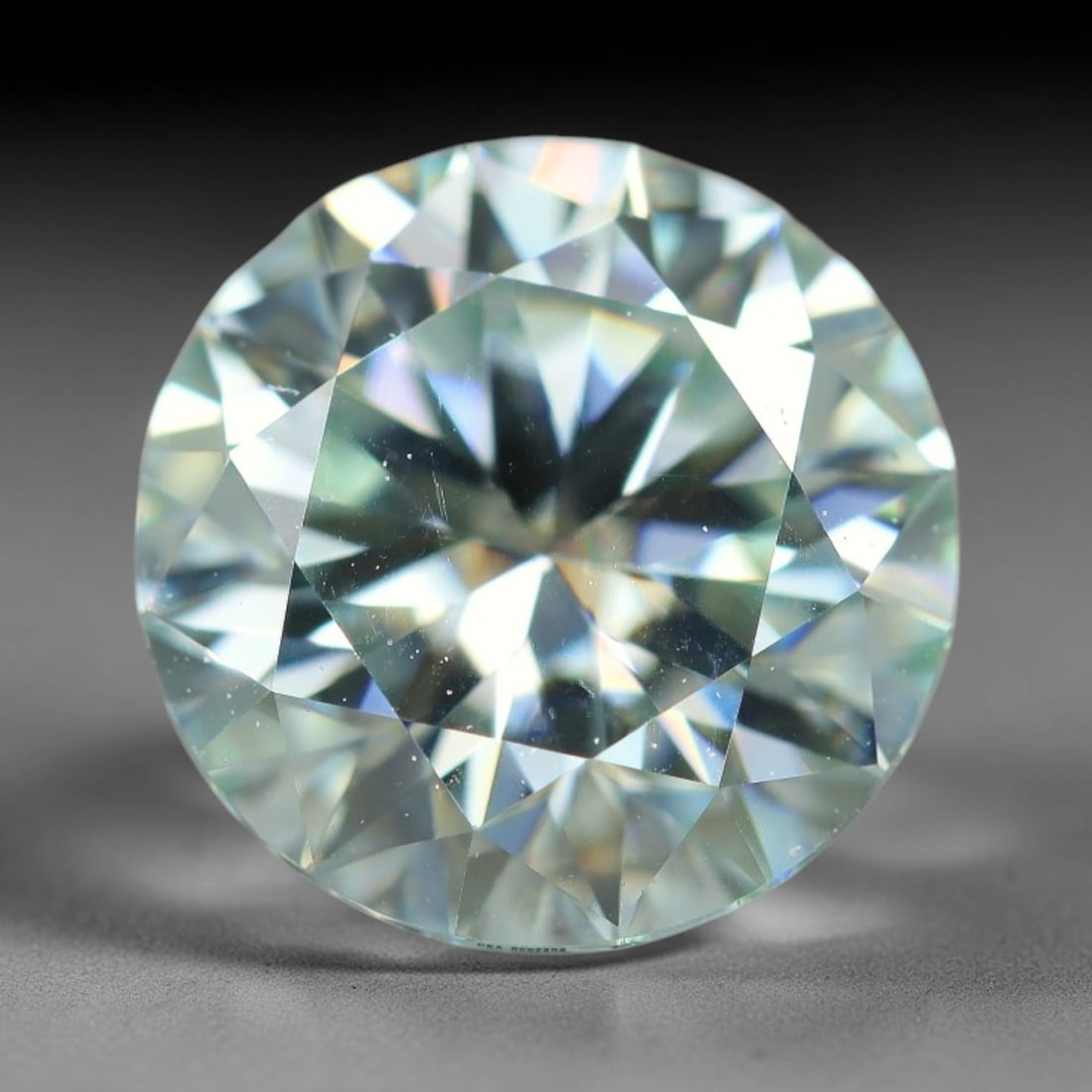 2.60 Carats Natural Cool White Moissanite Loose Gemstone, 14FL: This cool white moissanite holds dimension measurements of 9x5.4mm, delivering exceptional light dispersion that generates vivid rainbow sparkle across its fully transparent body, with faint microscop