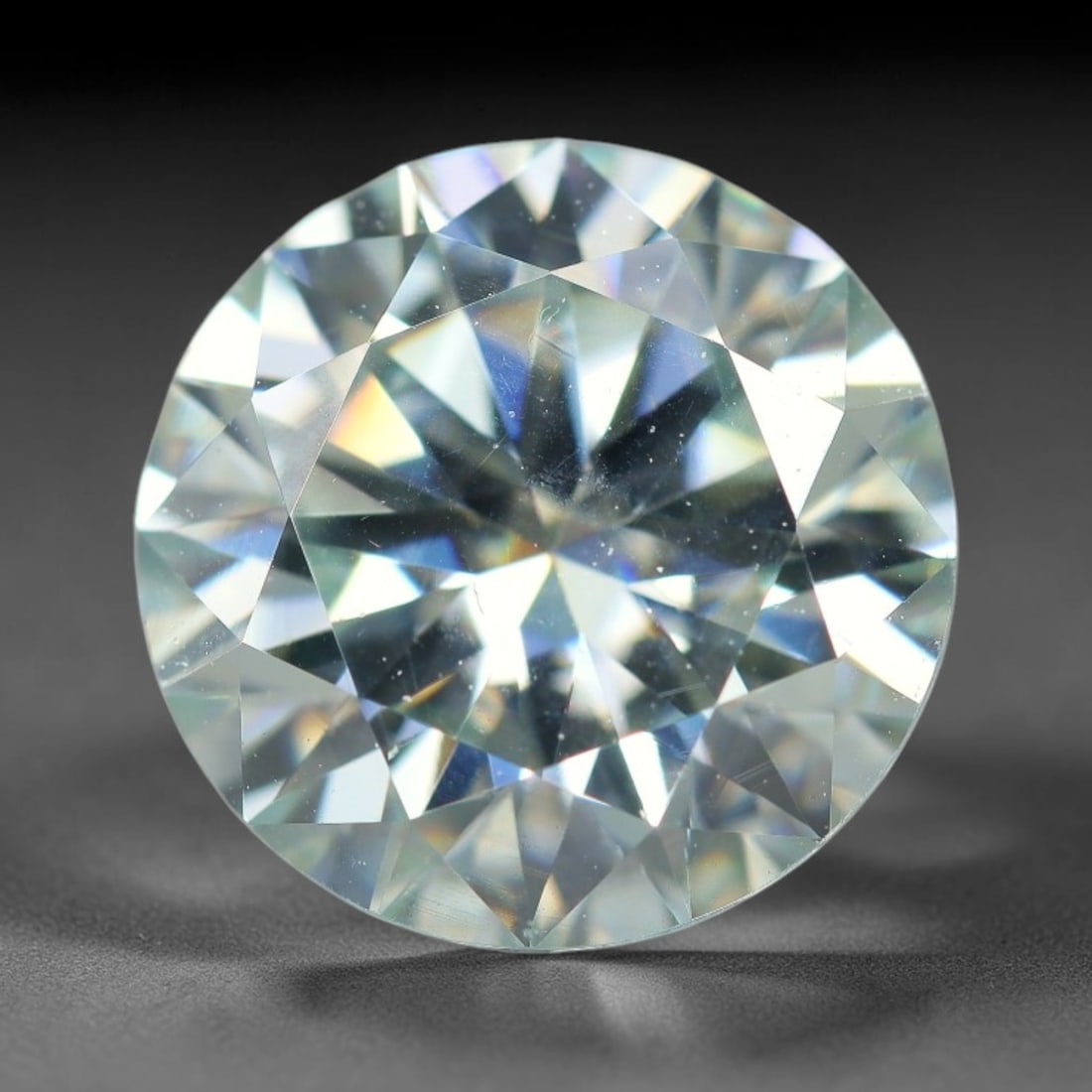2.55 Carats Natural Cool White Moissanite Loose Gemstone, 43FE: This cool white moissanite holds dimension measurements of 9x5.4mm, delivering exceptional light dispersion that generates vivid rainbow sparkle across its fully transparent body, with faint microscop