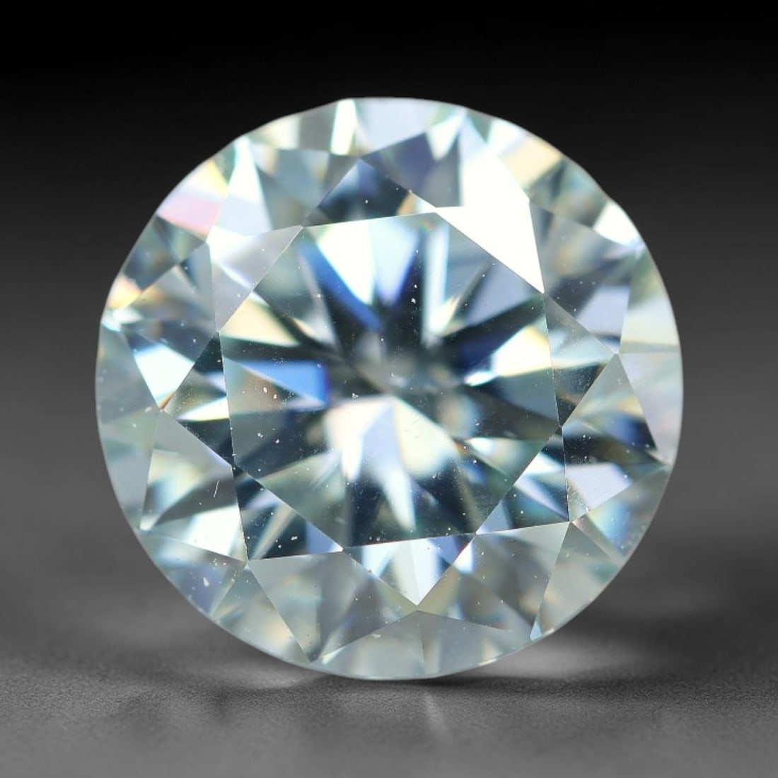 2.50 Carats Natural Cool White Moissanite Loose Gemstone, 17FL: This cool white moissanite holds dimension measurements of 9x5.4mm, delivering exceptional light dispersion that generates vivid rainbow sparkle across its fully transparent body, with faint microscop