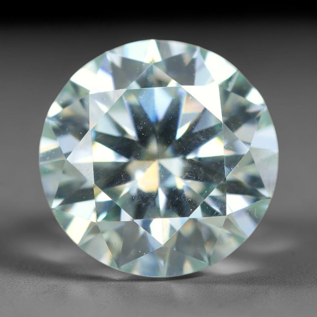 2.50 Carats Natural Cool White Moissanite Loose Gemstone, 16FL: This cool white moissanite holds dimension measurements of 9x5.3mm, delivering exceptional light dispersion that generates vivid rainbow sparkle across its fully transparent body, with faint microscop
