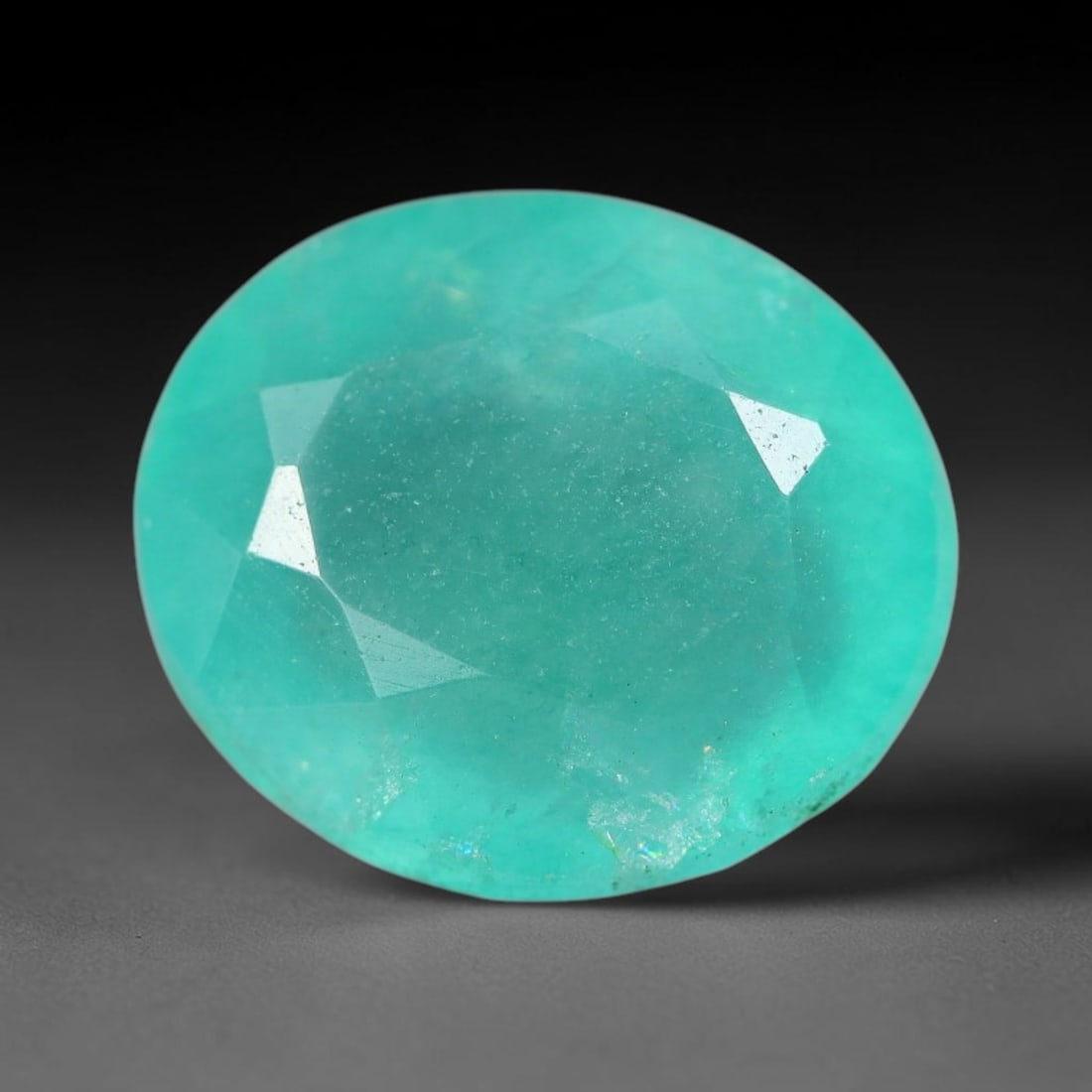 6.68 Carats Natural Brazilian Soft Mint Green Beryl Loose Gemstone, 99FE: This natural Brazilian green beryl measures 12.5x10.8x7mm, presenting a soft uniform mint green tone throughout its translucent crystal matrix, dotted with fine scattered dark mineral specks and subtl