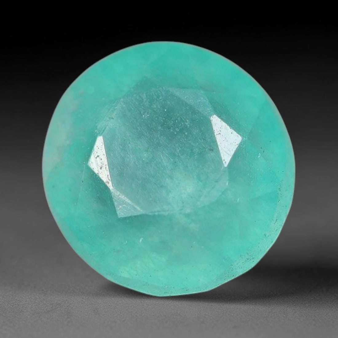 3.46 Carats Natural Brazilian Soft Mint Green Beryl Loose Gemstone, 4FE: This natural Brazilian green beryl measures 9.2x8.7x6.2mm, presenting a soft uniform mint green tone throughout its translucent crystal matrix, dotted with fine scattered dark mineral specks and subtl
