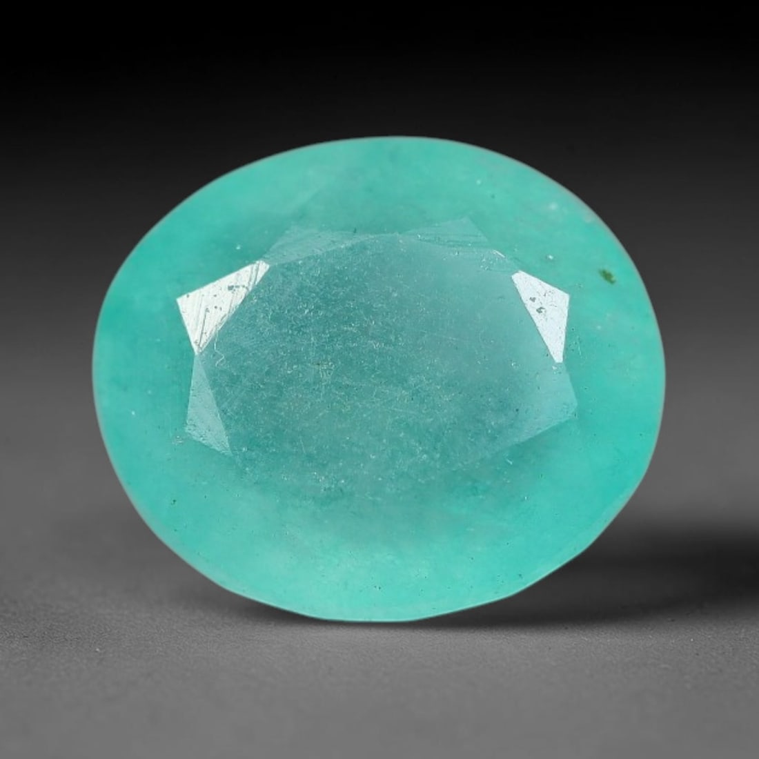 3.86 Carats Natural Brazilian Soft Mint Green Beryl Loose Gemstone, 3FE: This natural Brazilian green beryl measures 10.5x9.1x5.7mm, presenting a soft uniform mint green tone throughout its translucent crystal matrix, dotted with fine scattered dark mineral specks and subt