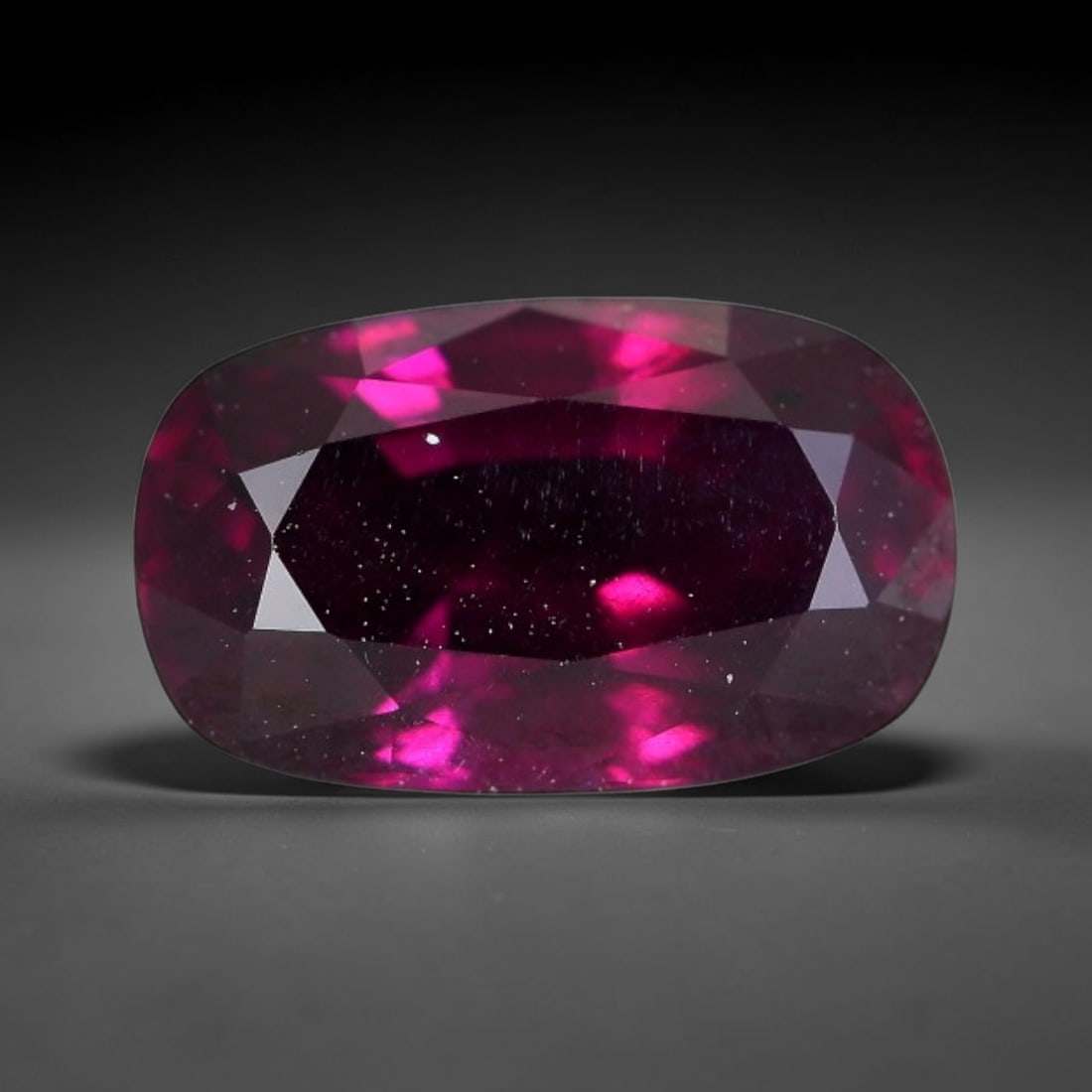 4.40 Carats Natural Mozambique Deep Fuchsia Rhodolite Garnet Loose Gemstone, 70FG: This natural Mozambique rhodolite garnet features dimensions of 11.5x7x5.6mm, holding a vivid deep fuchsia-pink color that glows brightly when light passes through its transparent body, with fine subt