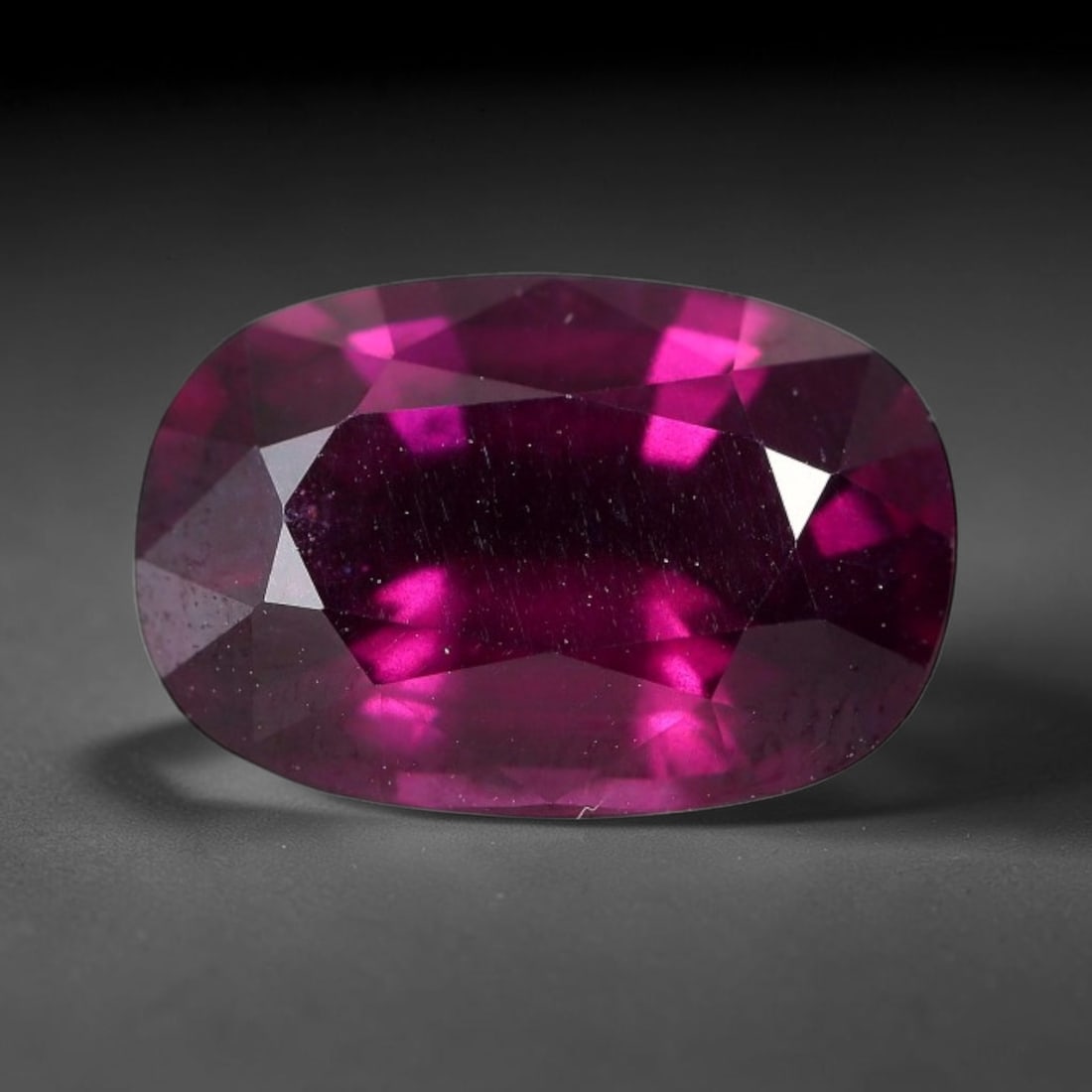 5.19 Carats Natural Mozambique Deep Fuchsia Rhodolite Garnet Loose Gemstone, 34FE: This natural Mozambique rhodolite garnet features dimensions of 12.3x8.3x5.6mm, holding a vivid deep fuchsia-pink color that glows brightly when light passes through its transparent body, with fine su