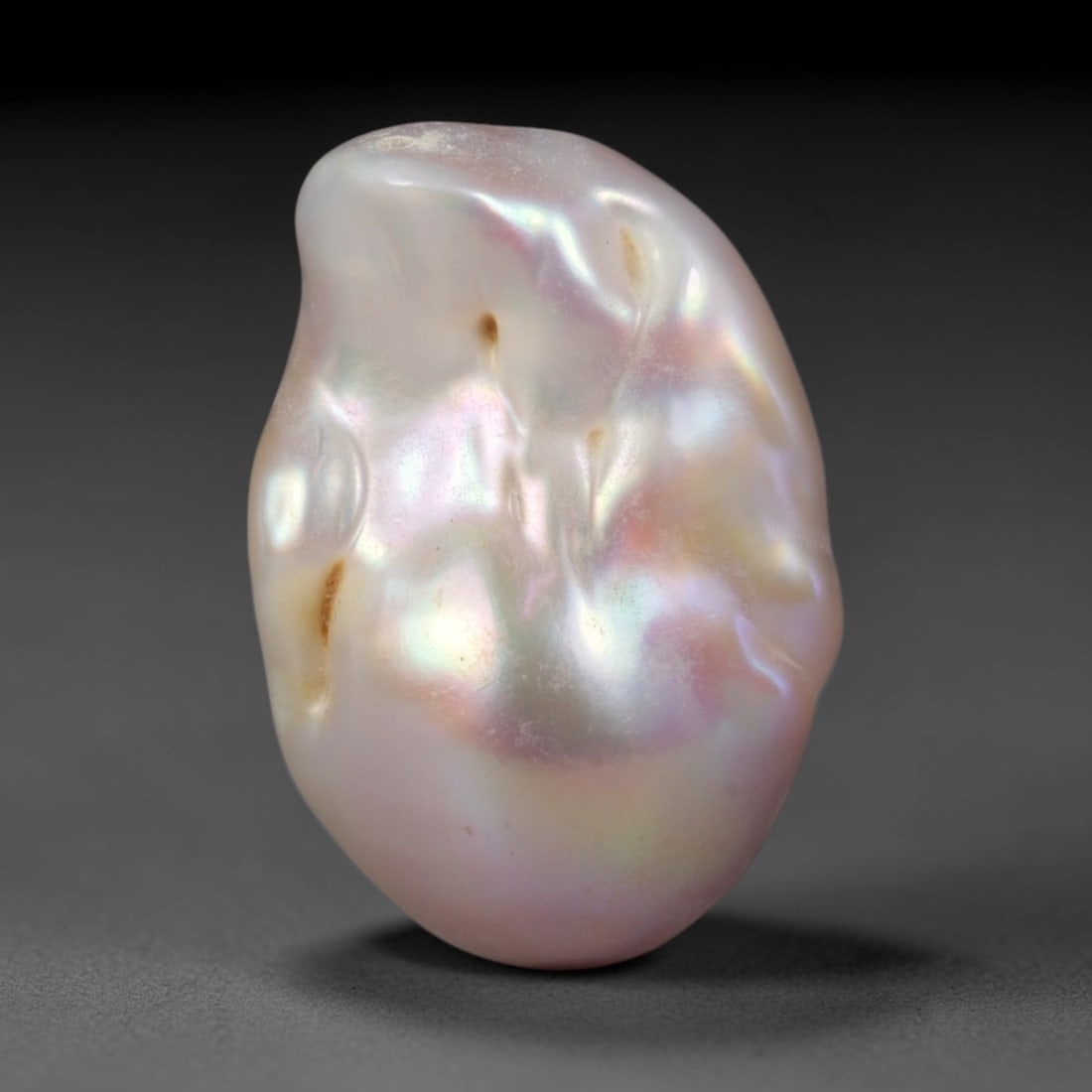 Natural Freshwater Keshi Pearl - Iridescent Baroque Pearl Ornament, 64AE, 64AE: A natural freshwater keshi pearl with organic asymmetrical baroque shaping, exhibiting soft creamy blush base tones with shifting pastel pink, lavender and pale gold iridescent luster across its smoot