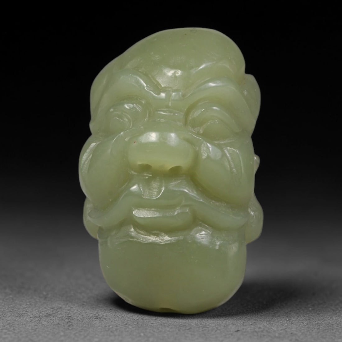 Natural Vintage Chinese Nephrite Jade Green Moustached Arhat Head Carved Face Bead, 98AA, 98AA: Hand-carved vintage Chinese strung bead crafted from natural vintage Chinese nephrite jade, measuring 3cm x 1.8cm. This barrel-shaped bead is delicately sculpted into a serene moustached Buddhist Arha