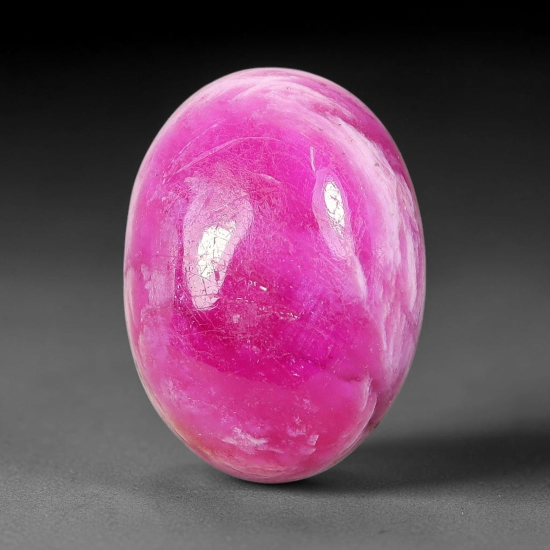 15 Carats Natural Mozambique Vivid Pink Red Ruby Loose Gemstone, 75FM: This polished Mozambique ruby cabochon measures 116.1x11.8x6.7mm, featuring striking natural swirling white mineral banding layered across a rich saturated pink red base that creates a unique organic 