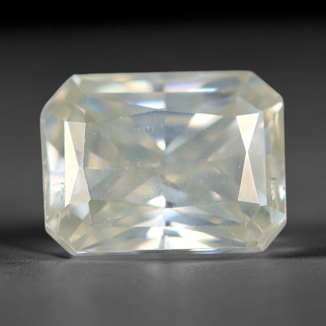 1.98 Carats Natural Cool White Moissanite Loose Gemstone, 87FM: This cool white moissanite holds dimension measurements of 8.5x6.4x4.1mm, delivering exceptional light dispersion that generates vivid rainbow sparkle across its fully transparent body, with faint mic