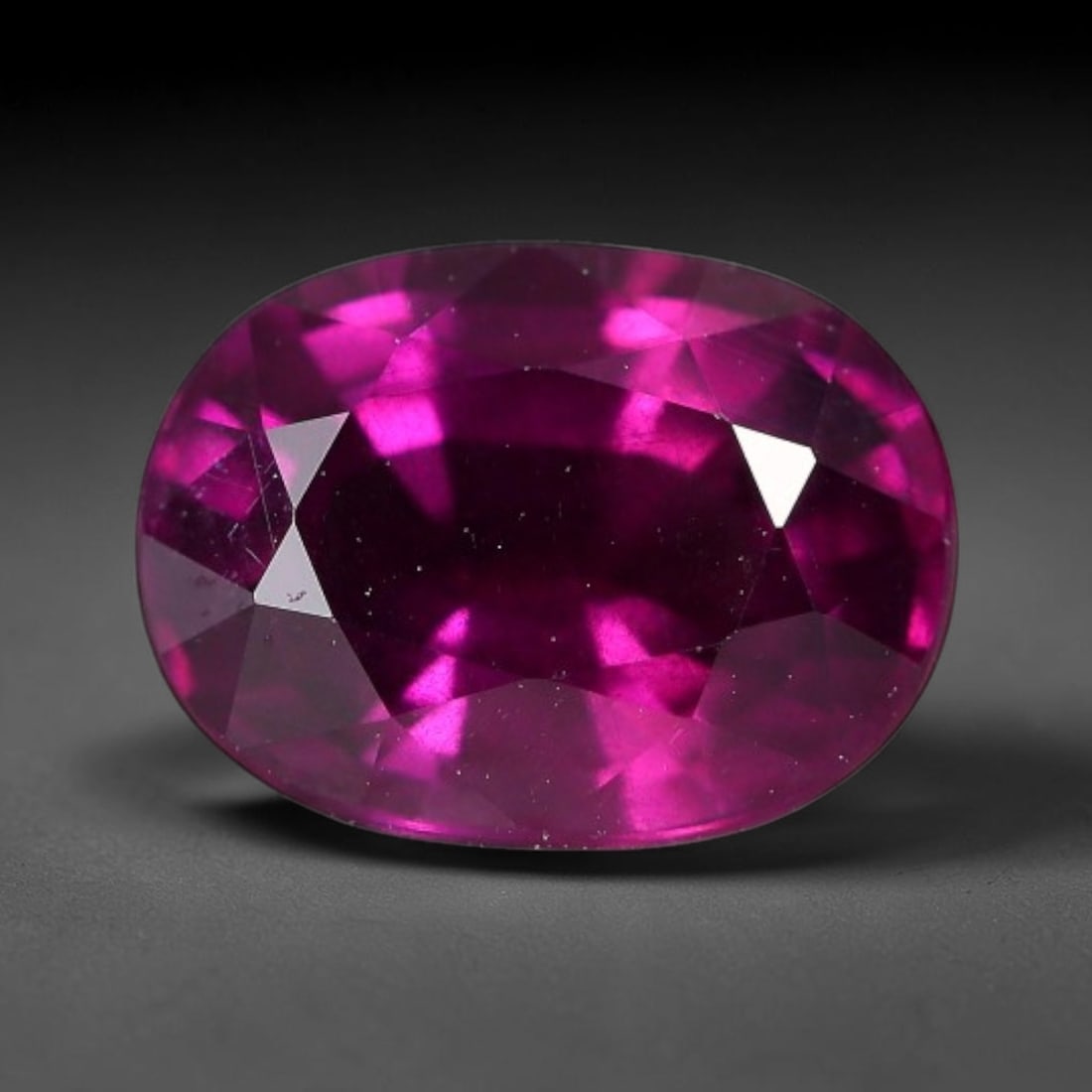 3.40 Carats Natural Mozambique Deep Fuchsia Rhodolite Garnet Loose Gemstone, 26FE: This natural Mozambique rhodolite garnet features dimensions of 9.8x7.3x5.3mm, holding a vivid deep fuchsia-pink color that glows brightly when light passes through its transparent body, with fine sub