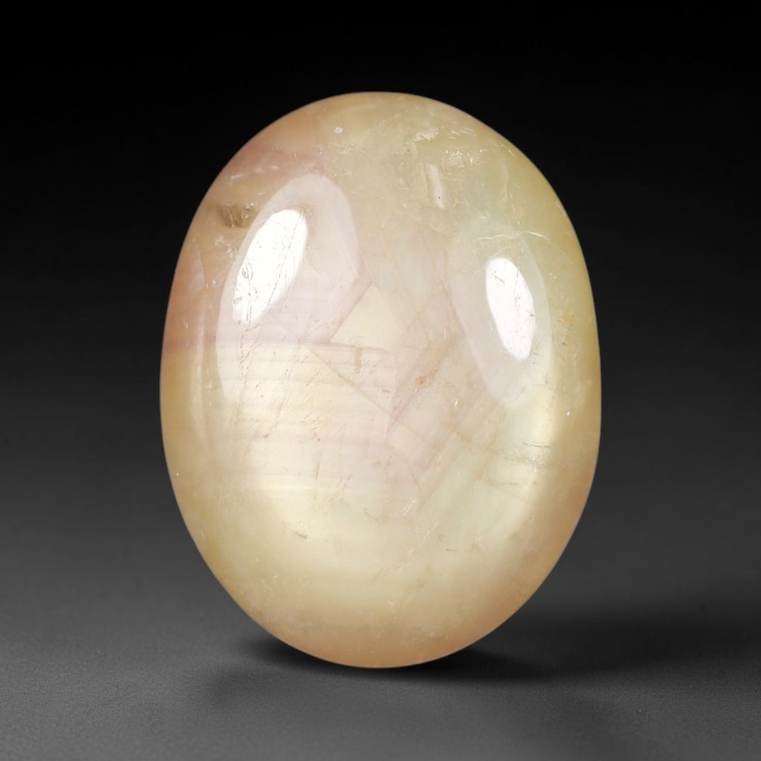 11.80 Carats Natural Madagascar Soft Rose Pink Heated Ruby Cabochon Loose Gemstone, 66FE: This warm blush-toned ruby cabochon carries blended swathes of soft rose pink and gentle peach undertones, with faint natural mineral veining throughout the polished dome, measured at 16.8x13.2x4.8mm.