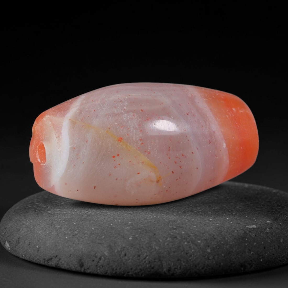 Ancient Achaemenid Persian Empire Orange Banded Agate Barrel Bead (550-330 BCE), 70AD: This antique banded agate barrel bead originates from the Achaemenid Persian Empire, the first unified Persian realm famed for sophisticated lapidary workshops crafting ceremonial agate talismans for 