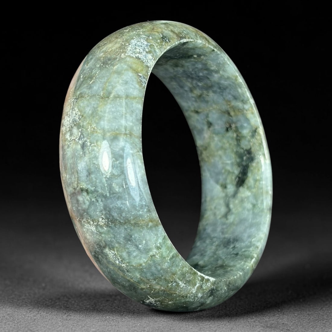 Natural Burmese Type A Dark Moss Green Jadeite Bangle, 57mm Inner Diameter, 36AV: Single wide polished solid bangle crafted from genuine untreated Natural Burmese Type A jadeite jade with a 57mm inner diameter. Features moody mixed deep forest green, grey, and dark mossy black natu