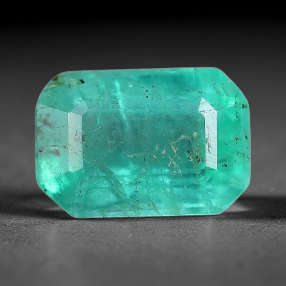 0.94 Carats Natural Zambian Green Emerald Loose Gemstone, 32AH: This green Zambian emerald holds smooth even saturation with subtle faint natural internal markings lending authentic organic character, measured at 6.6x4.5x3.8mm, its calm cool green tone delivers un