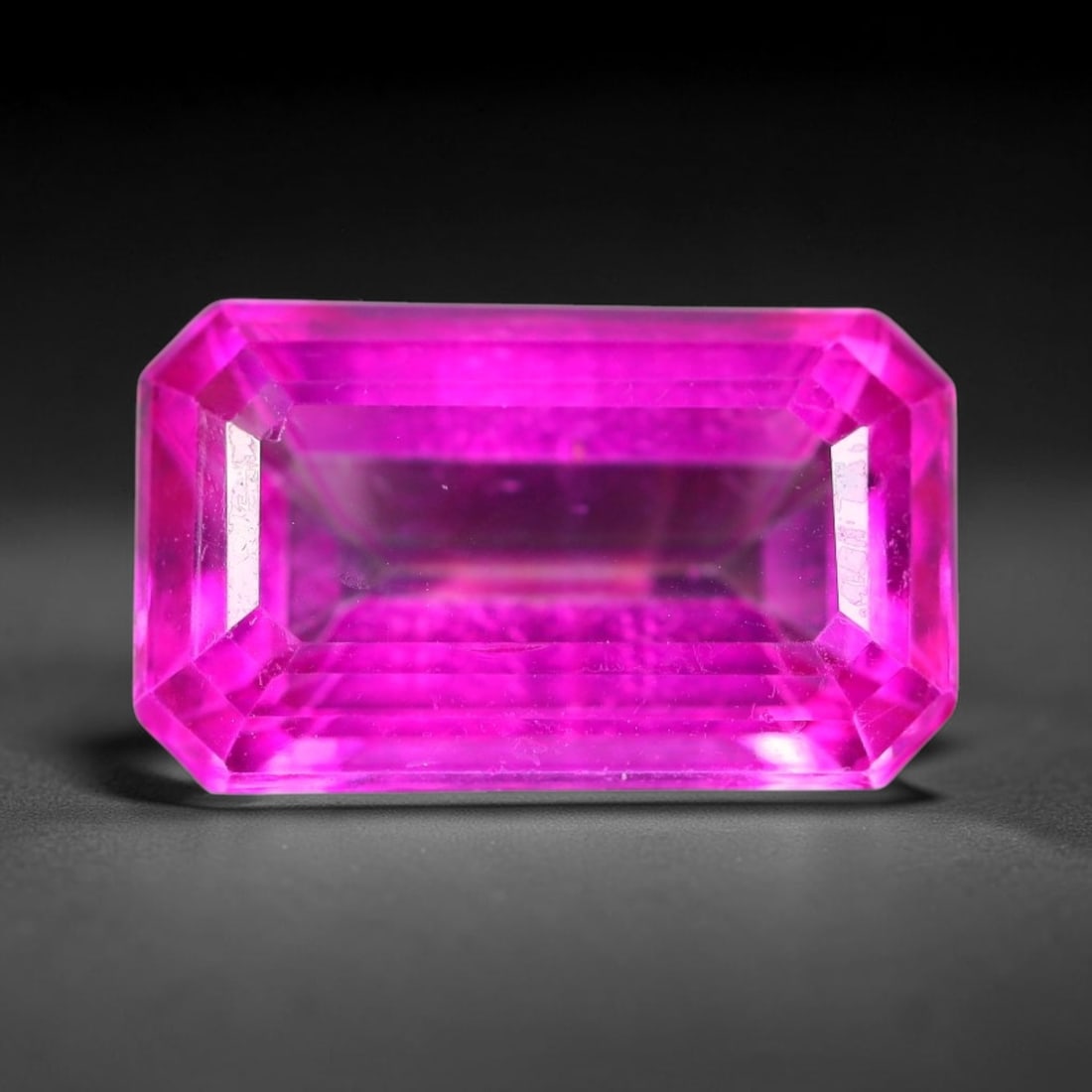 9.10 Carats Natural Brazil Hot Pink Topaz Loose Gemstone, 12FE: This natural Brazil topaz holds dimension measurements of 15.1x9.1x6.3mm, displaying an intense vibrant hot pink shade created through surface color coating treatment, its transparent crystal body car