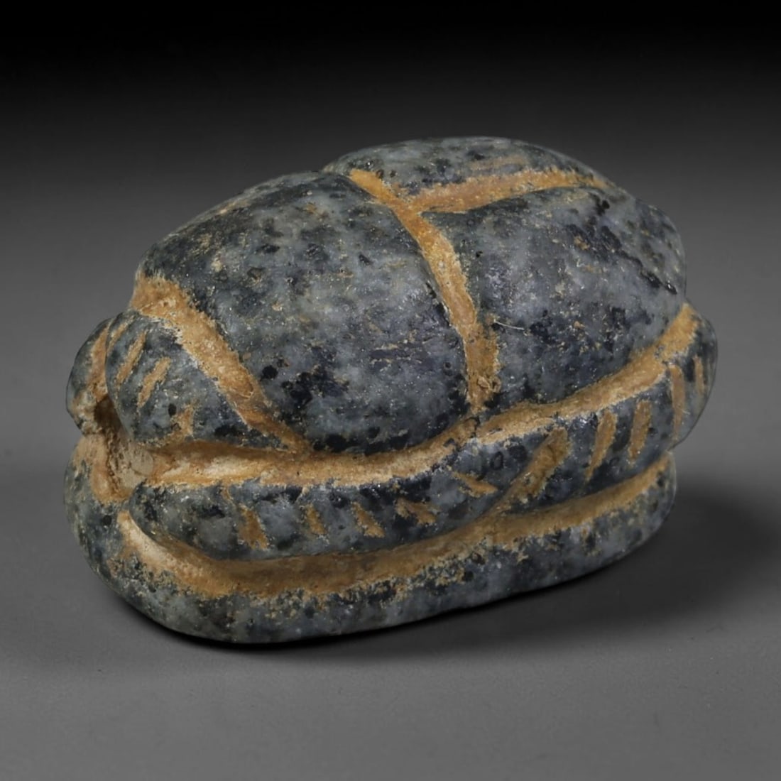 Ancient Predynastic & Pharaonic Egyptian Stone Scarab Amulet (4000 BCE-30 CE), 57AB: This dark speckled stone scarab originates from Predynastic & Pharaonic Egyptian Civilization, core funerary talismans symbolizing rebirth and divine protection for interment burials. Hand incised car