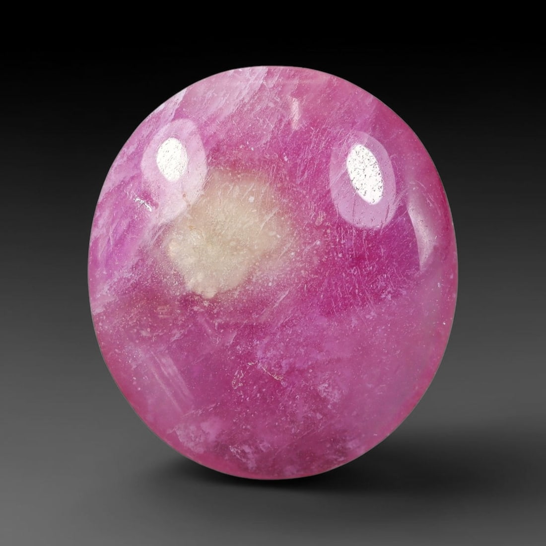 17.32 Carats Natural Mozambique Bicolor Ruby Loose Gemstone, 52FG: This natural Mozambique bicolor ruby cabochon holds dimension measurements of 19.3x17.3x5.1mm, displaying soft swirled intermix of rich pink and pale creamy mineral tones that blend seamlessly across 