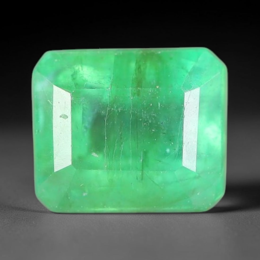 0.94 Carats Natural Zambian Green Emerald Loose Gemstone, 9FP: This green Zambian emerald holds smooth even saturation with subtle faint natural internal markings lending authentic organic character, measured at 6.1x5x3.9mm, its calm cool green tone delivers unde
