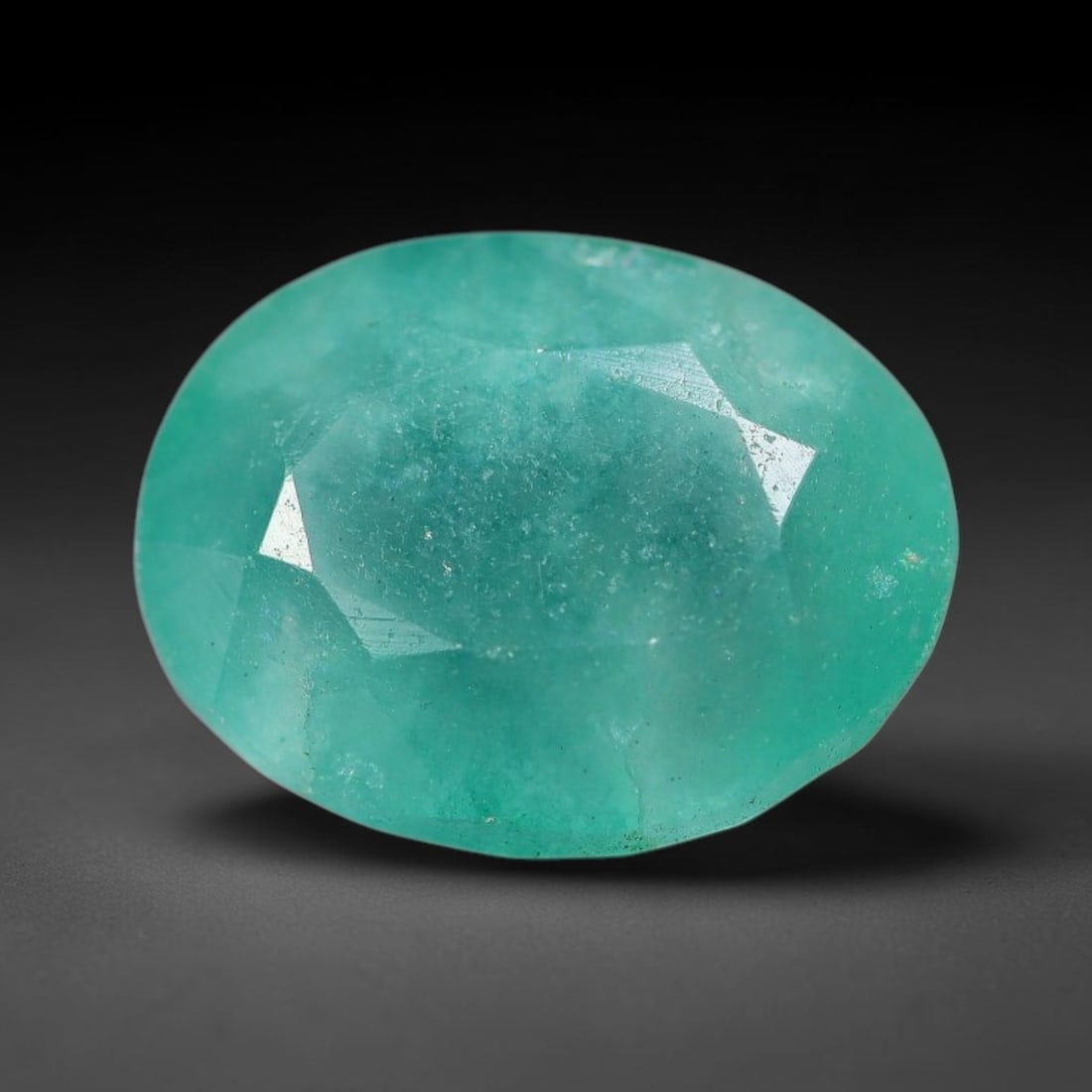 5.93 Carats Natural Brazilian Soft Mint Green Beryl Loose Gemstone, 8FE: This natural Brazilian green beryl measures 12.5x9.7x6.9mm, presenting a soft uniform mint green tone throughout its translucent crystal matrix, dotted with fine scattered dark mineral specks and subt