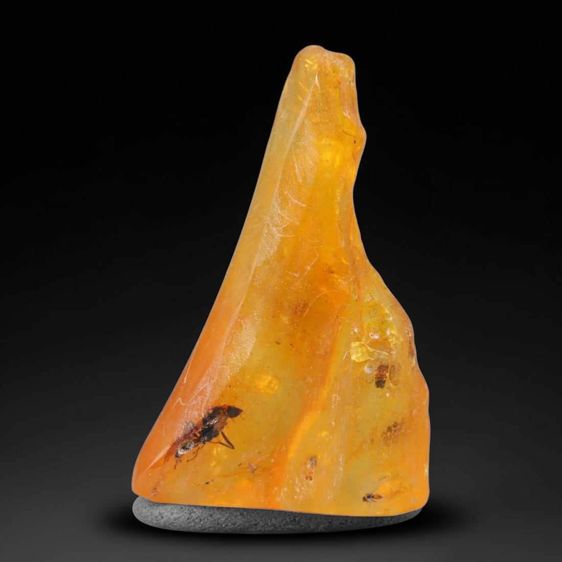 16.15ct Natural Baltic Polished Loose Freeform Amber Gemstone, 24AT: This smoothly polished freeform amber piece carries warm translucent organic clarity with fine natural fossil flecks and tiny mineral inclusions suspended throughout its 35x22mm flowing unstructured s