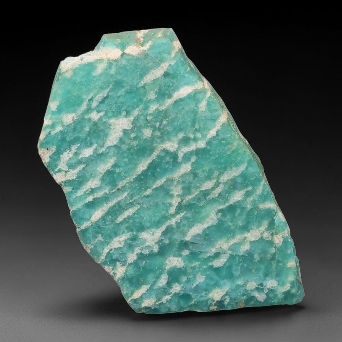 60ct Natural Russian Ural Amazonite Slab Rough, 82EB: This intact amazonite slab features distinct parallel mineral banding running uniformly across its naturally split flat surface within 44x25x6mm slab dimensions, retaining unmodified natural geologica
