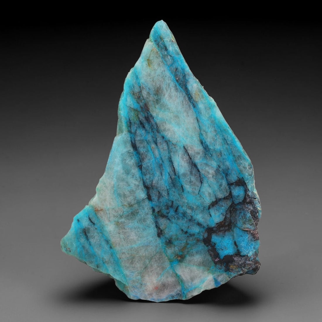 145ct Natural Peruvian Chrysocolla Polished Slab Rough, 80AR: This partial-polished chrysocolla slab features blended mineral matrix with smooth refined face and unaltered natural rugged edge across its 62x46x6mm elongated form, translucent mineral layers hold s
