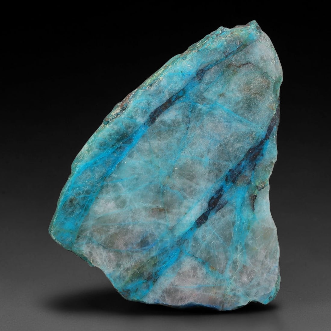 110ct Natural Peruvian Chrysocolla Polished Slab Rough, 67AR: This partial-polished chrysocolla slab features blended mineral matrix with smooth refined face and unaltered natural rugged edge across its 56x44x5mm elongated form, translucent mineral layers hold s